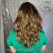 Heather wearing the Leighton Wig in Cocoa Swirl Rooted, shown from the back, studio