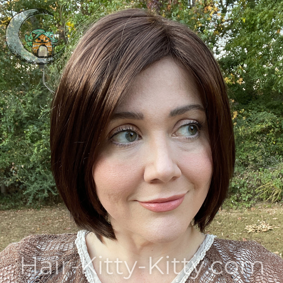 The Suri Wig in the color  Ginger Snap, modelled by Heather, slightly turned view
